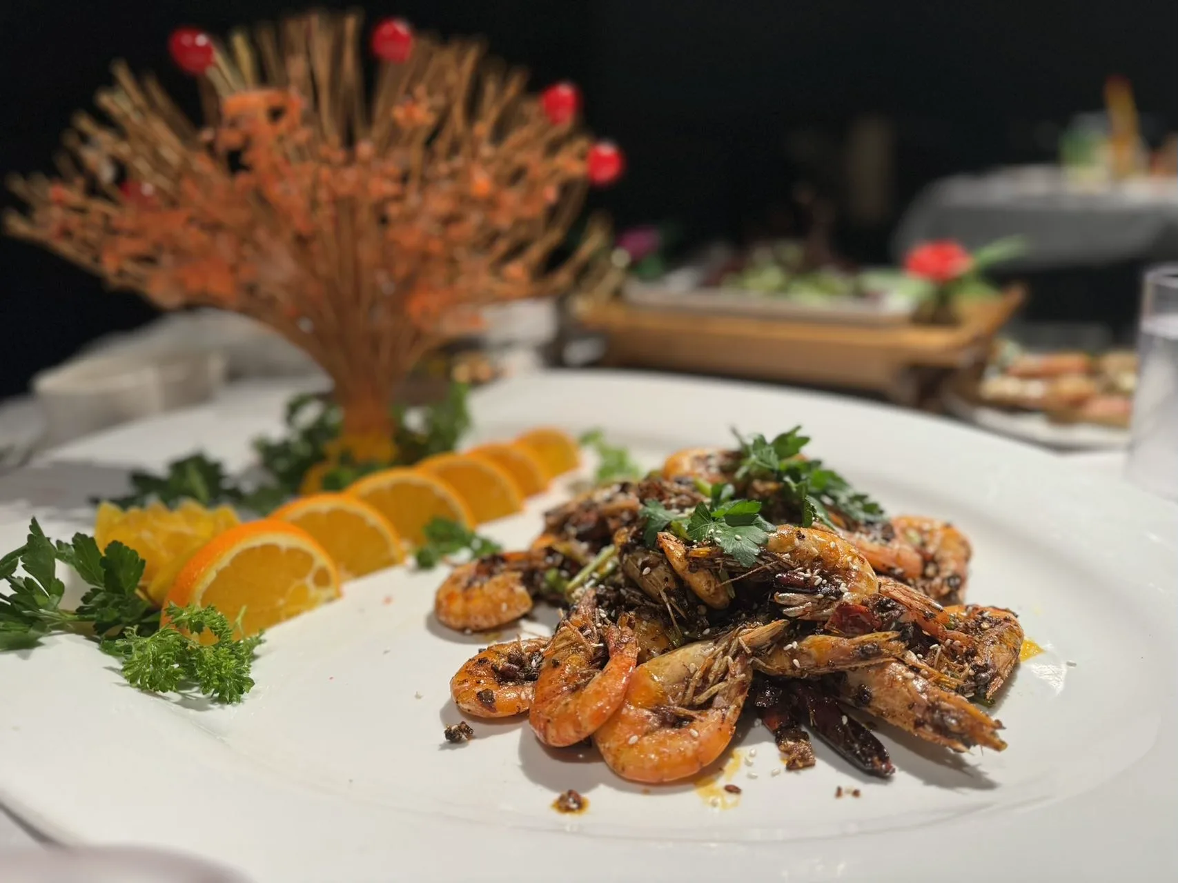 Grilled shrimp with sesame and orange garnish