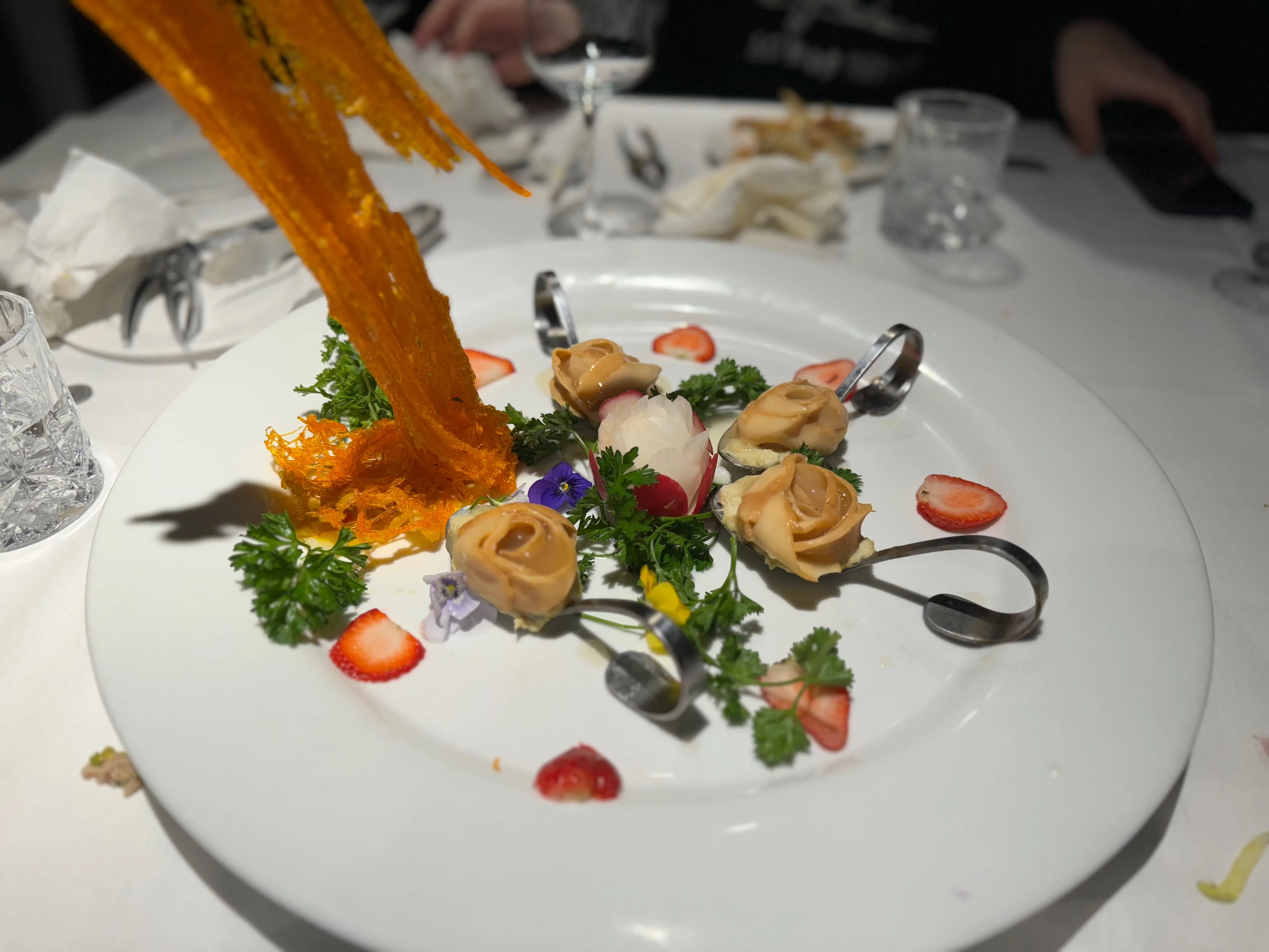 Artfully plated scallop rosettes with spun sugar at Sky Pavilion