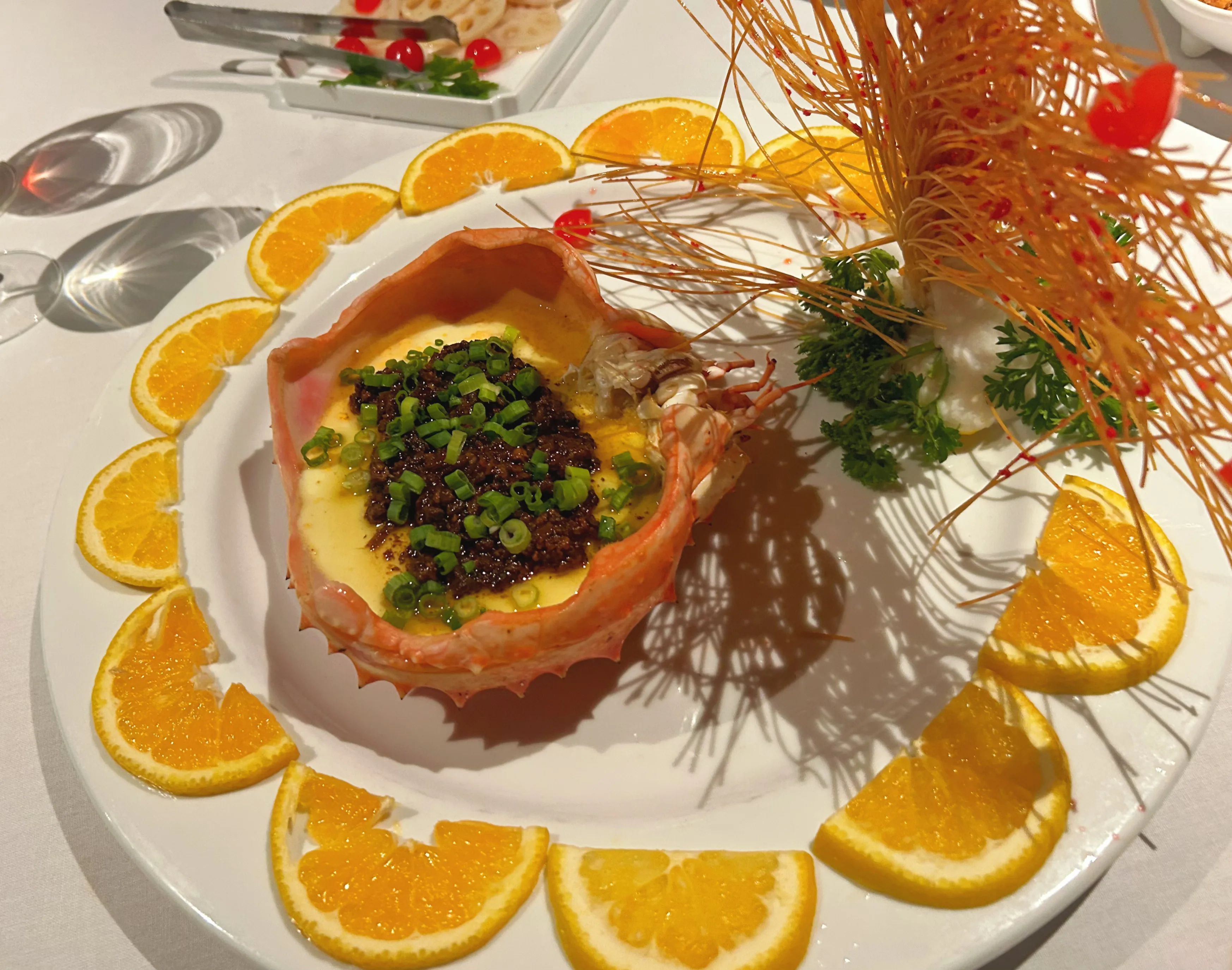 Crab presentation with citrus and vegetable garnish