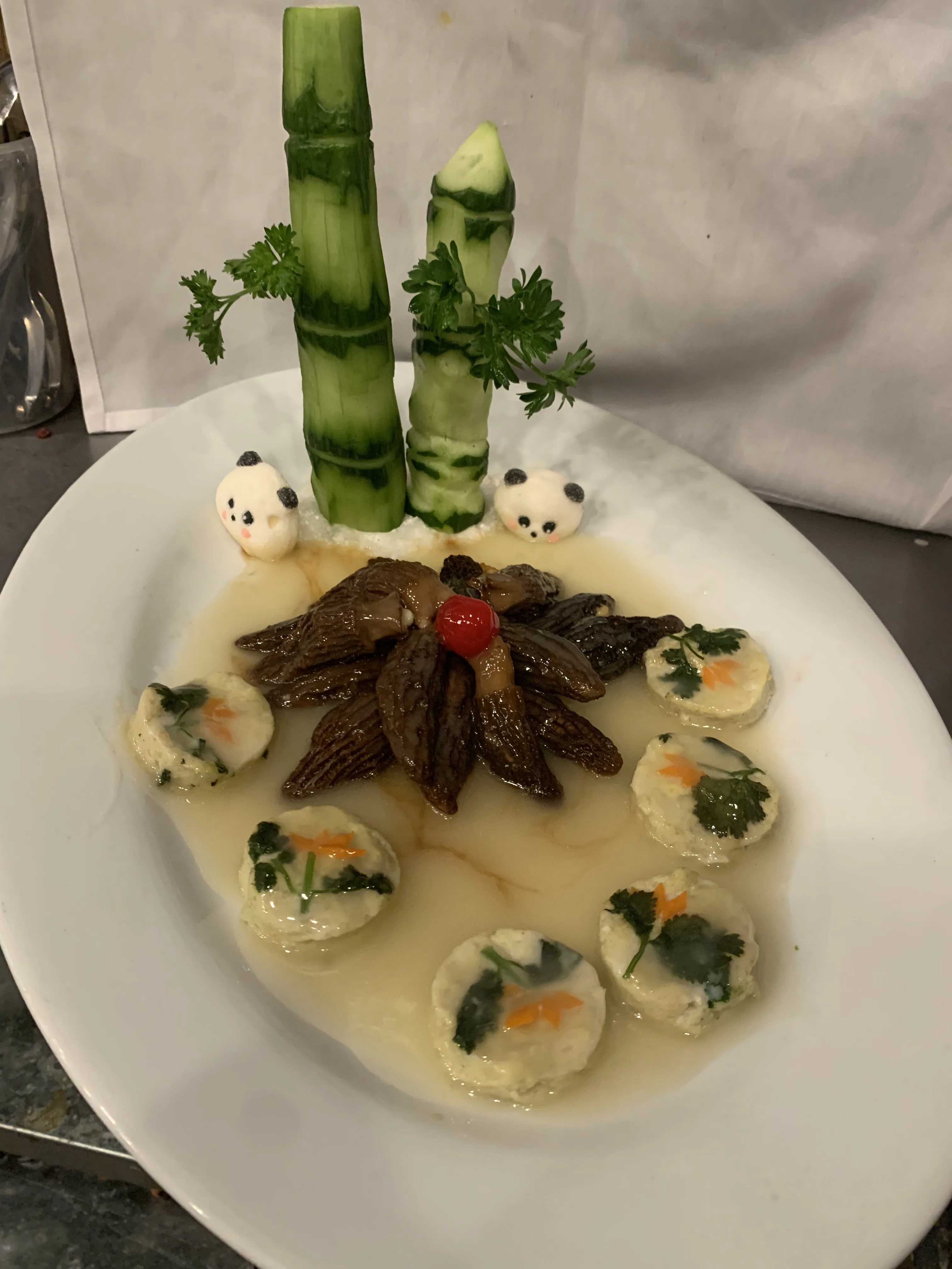 Braised morels with panda-shaped garnish and tofu rounds