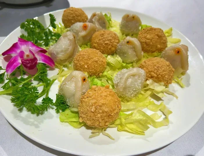 Fried dumplings with orchid garnish